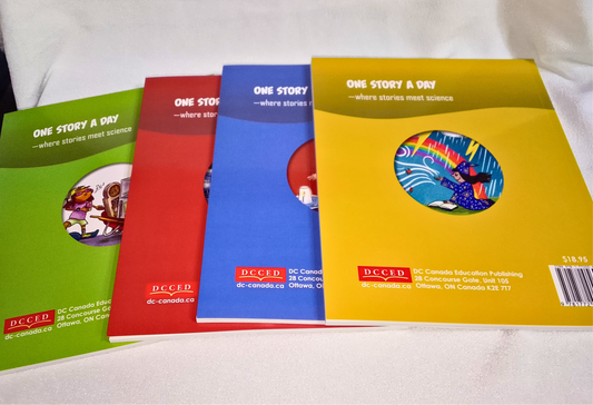 Four colorful books with different colored covers on a white surface