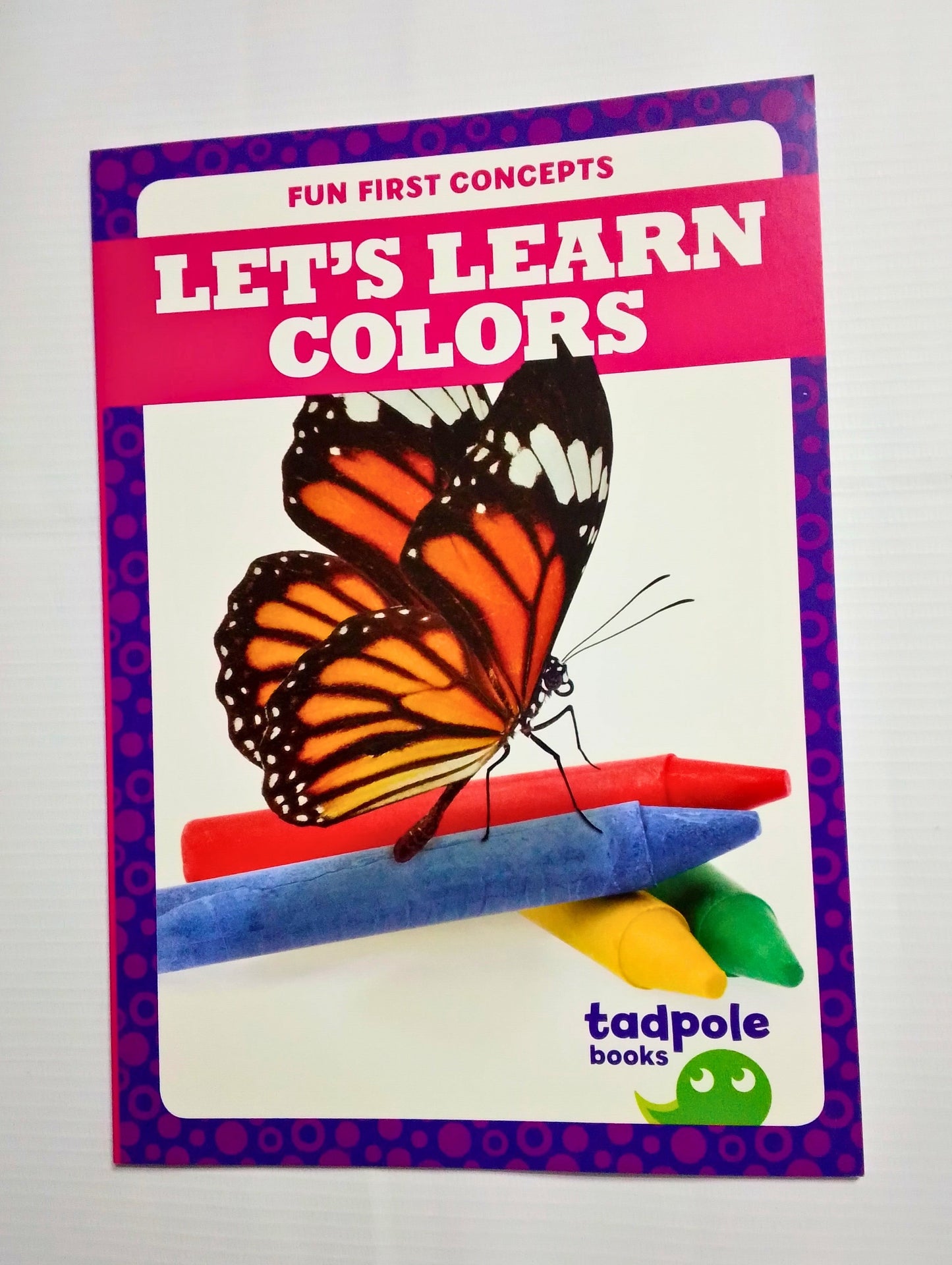 Book titled 'Let's Learn Colors' with a butterfly and crayons on the cover, published by tadpole books.