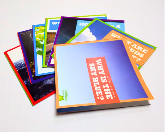 Stack of colorful photo albums on a white background