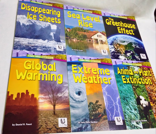 Collection of books on environmental topics with colorful covers on a white surface.