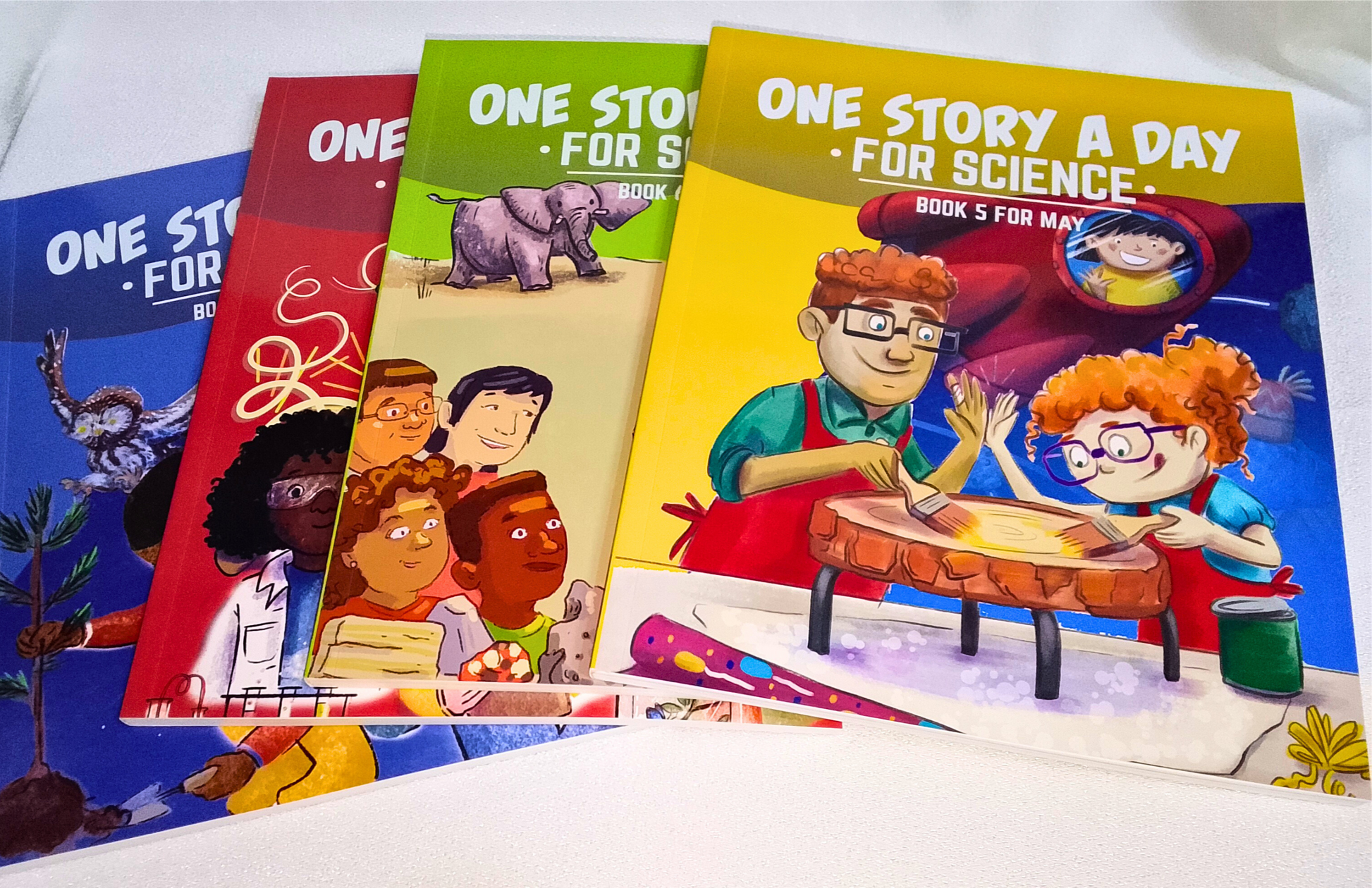 Four children's books titled 'One Story A Day For Science' on a white surface.
