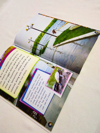 Open book with nature-themed illustrations and text on a light background