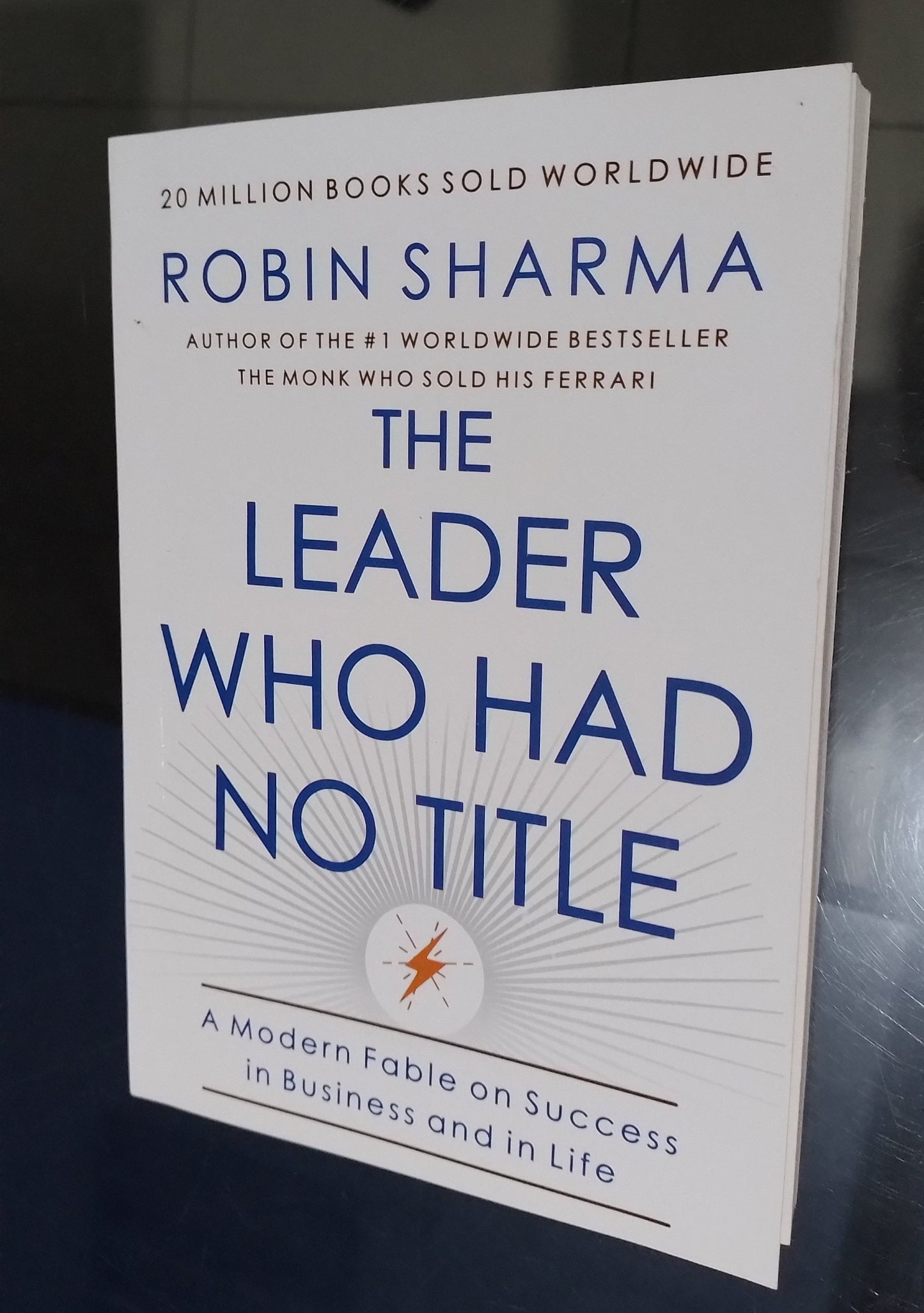 Book titled 'The Leader Who Had No Title' by Robin Sharma on a dark background