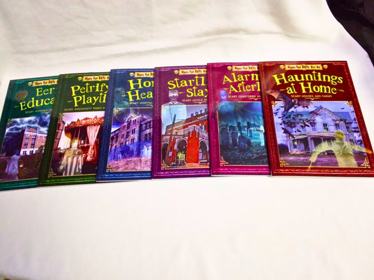 Row of books with colorful covers on a white surface