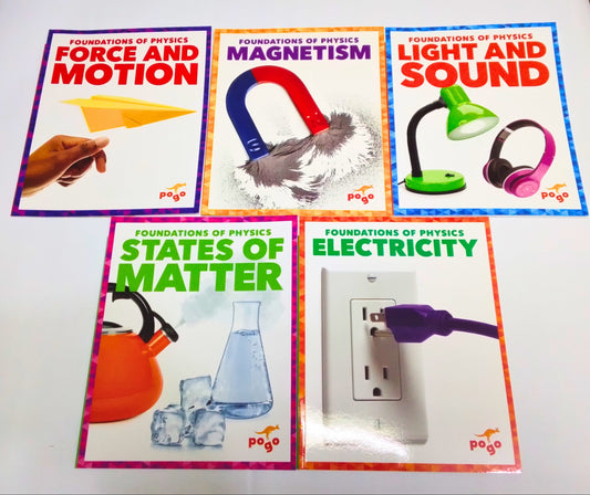 Set of educational posters on a table covering topics like force and motion, magnetism, light and sound, states of matter, and electricity.