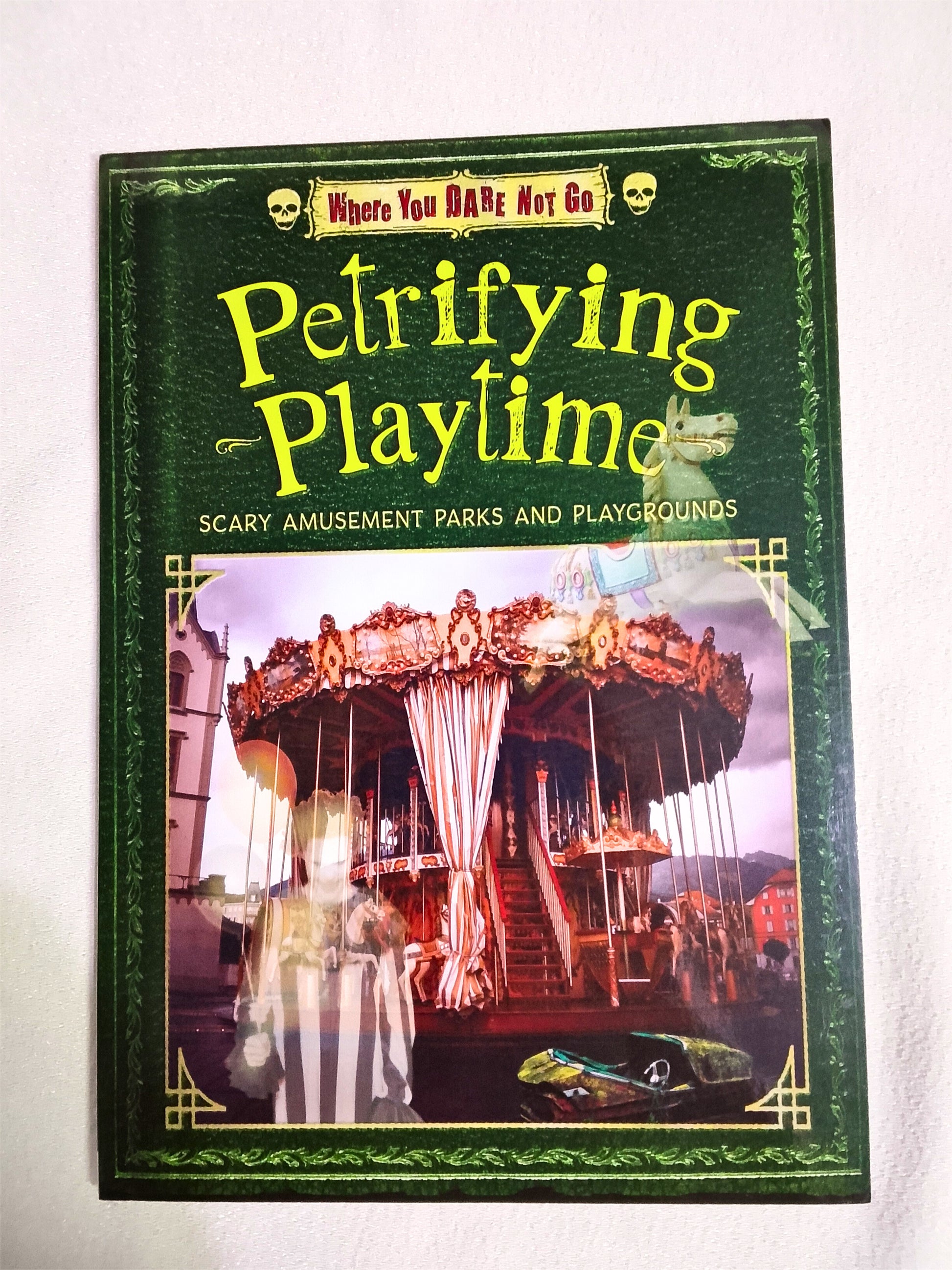 Book cover of 'Petrifying Playtime' with a carousel and ghostly figure on a white background